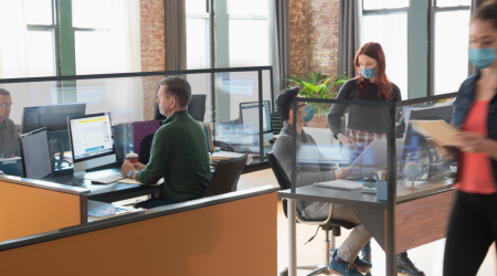 People in an office setting - some wearing masks